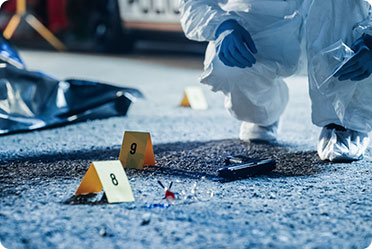 A person in a white suit and gloves examining a crime scene, carefully analyzing the evidence.