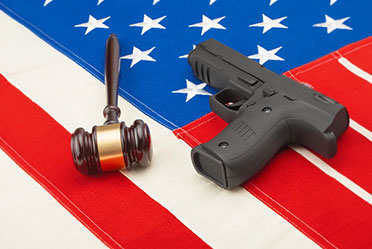 Image showing gun and gavel on US flag