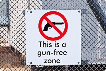 A sign on a chain link fence stating 