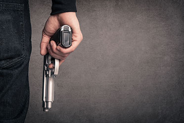 A person holding a gun in their hand.