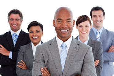 A group of business professionals standing together in a modern office setting.