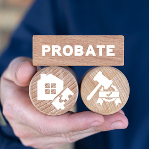 Hand holding wooden block labeled 'PROBATE' with estate and legal icons - Alex Kincaid Law